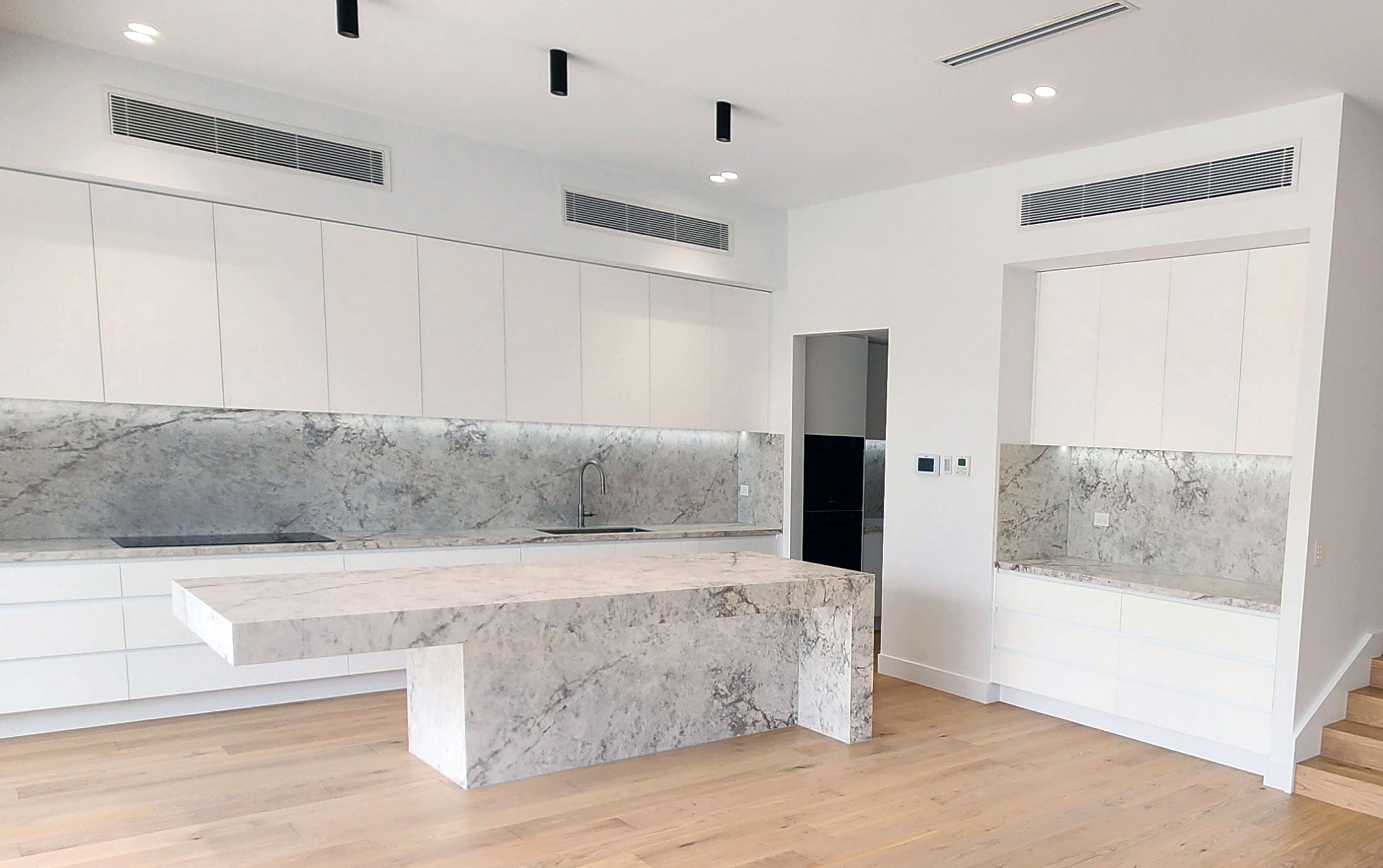 Luxury kitchen in a Balwyn custom home featuring stone surfaces and high-end joinery.</p>
<p>