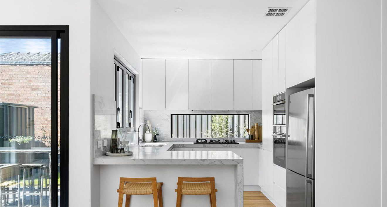 Modern kitchen and lounge area in an Ivanhoe multi-unit development, combining style and comfort.</p>
<p>